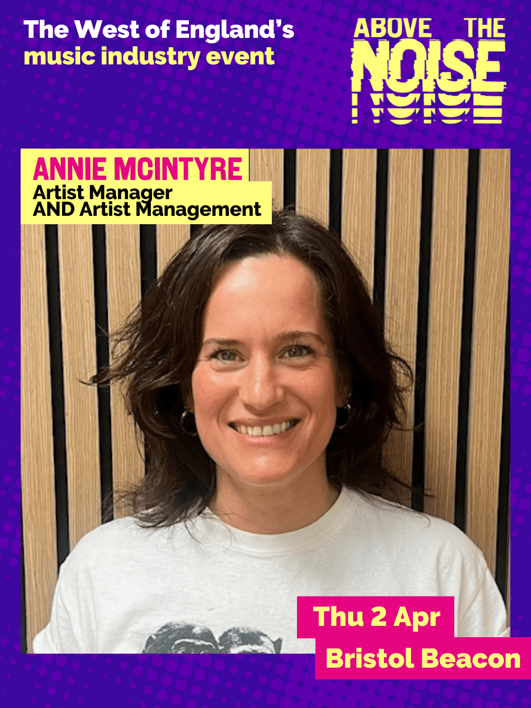 Annie McIntyre - Artist Manager, AND Artist Management. Thu 2 Apr, Bristol Beacon. A smiling person with shoulder-length dark hair wearing a white t-shirt poses in front of a wall of wooden panels.
