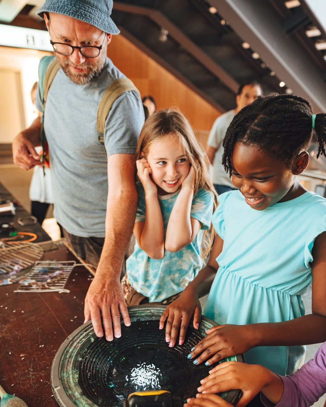 Two young children play with an interactive display